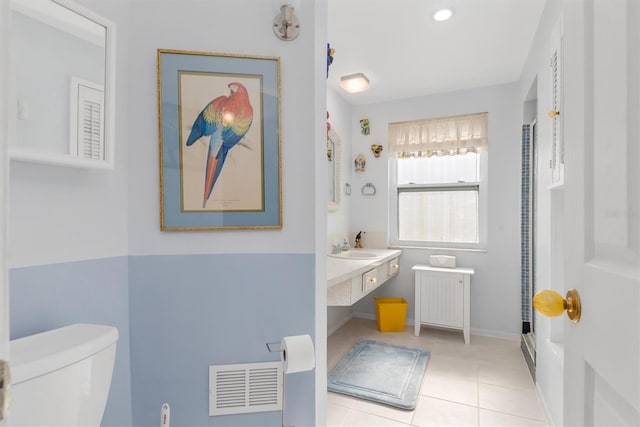 bathroom with tile patterned flooring, sink, and toilet