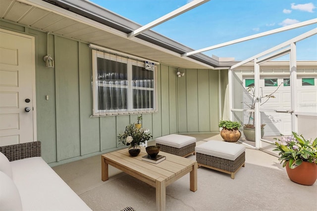 view of patio / terrace with an outdoor hangout area and glass enclosure