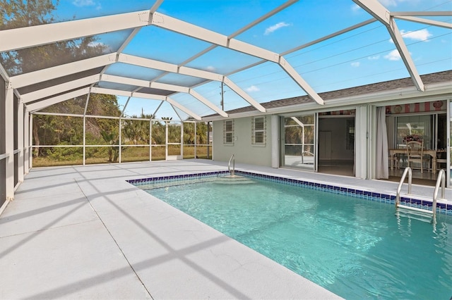 view of swimming pool featuring a lanai and a patio