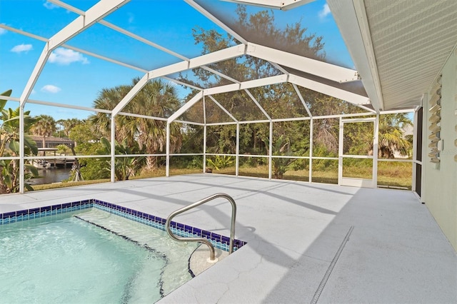 view of swimming pool featuring a water view, a lanai, and a patio area