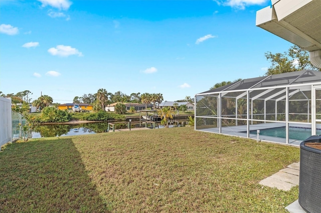 view of yard with a water view and a lanai