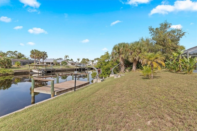 dock area featuring a water view and a yard