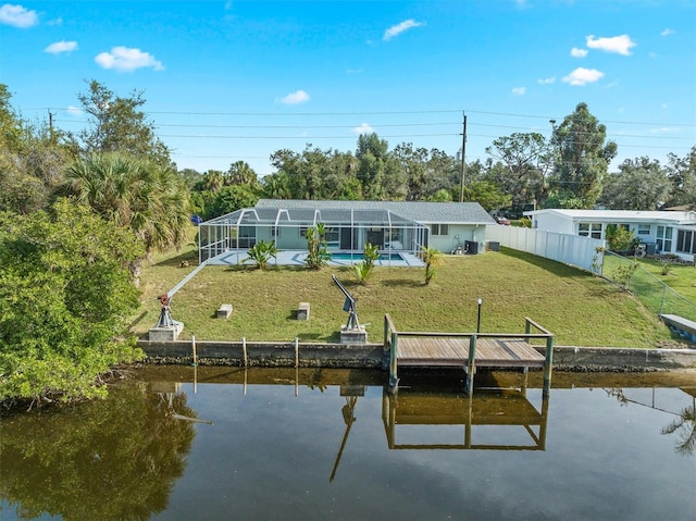 rear view of property with a lawn, a water view, and glass enclosure