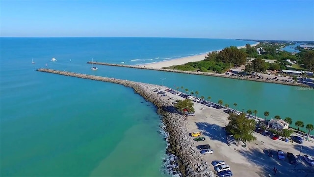 bird's eye view featuring a water view and a beach view