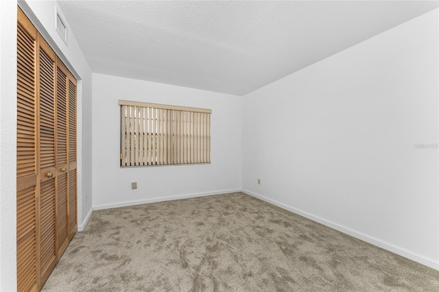 unfurnished bedroom featuring carpet floors and a closet