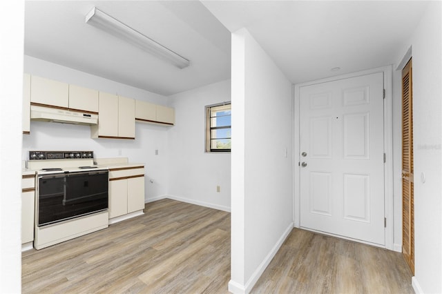 kitchen featuring white electric range, cream cabinets, and light wood-type flooring