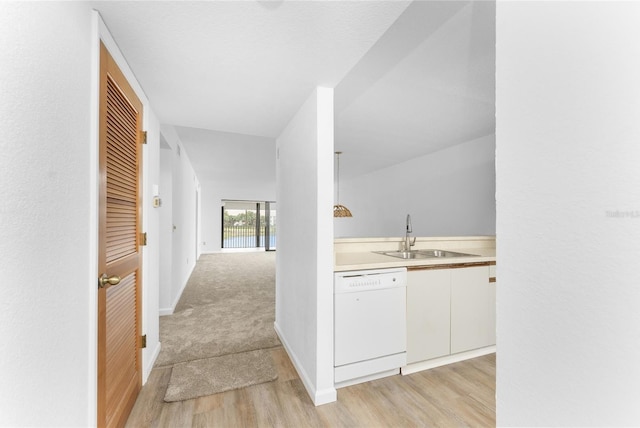 interior space with dishwasher, sink, white cabinets, and light hardwood / wood-style floors