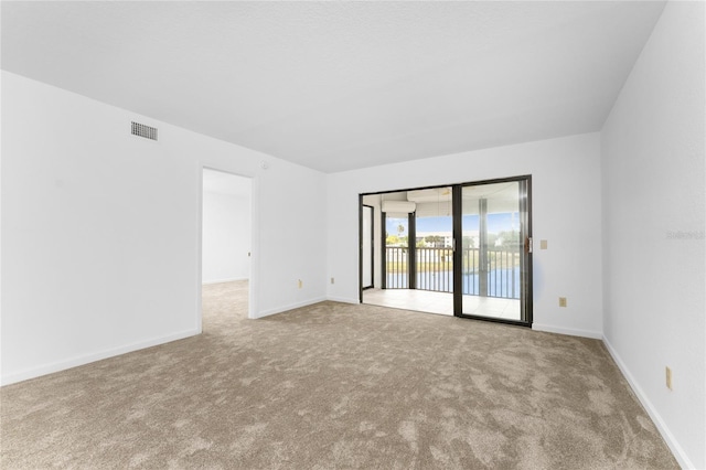 carpeted spare room with french doors