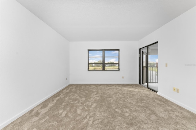 unfurnished room with light carpet