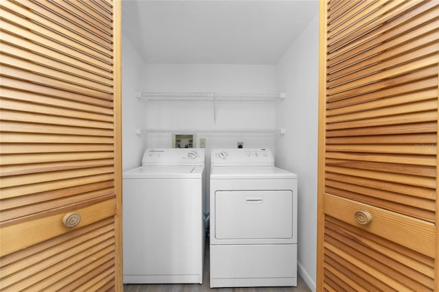 clothes washing area with washing machine and dryer