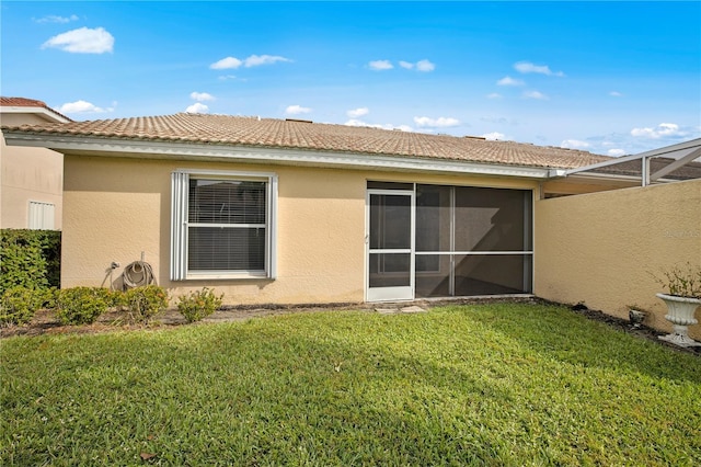 rear view of house featuring a lawn