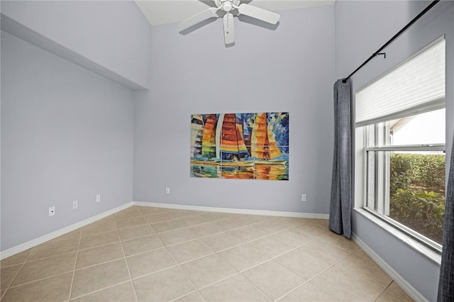 tiled empty room with ceiling fan