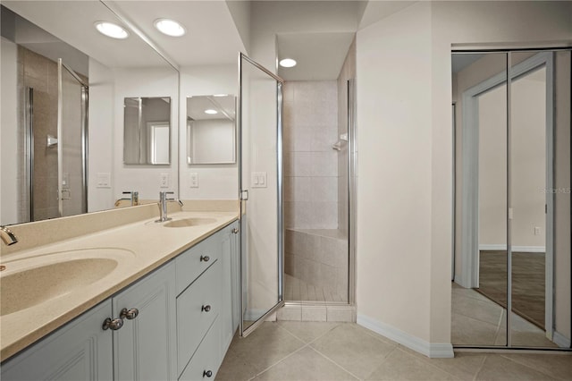 bathroom with tile patterned flooring, vanity, and a shower with shower door