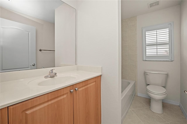 bathroom featuring tile patterned flooring, vanity, and toilet