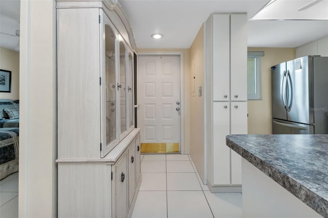 kitchen featuring stainless steel fridge and light tile patterned flooring