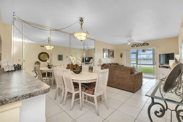 tiled dining space featuring ceiling fan