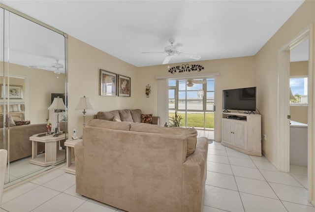 living room with ceiling fan and light tile patterned floors