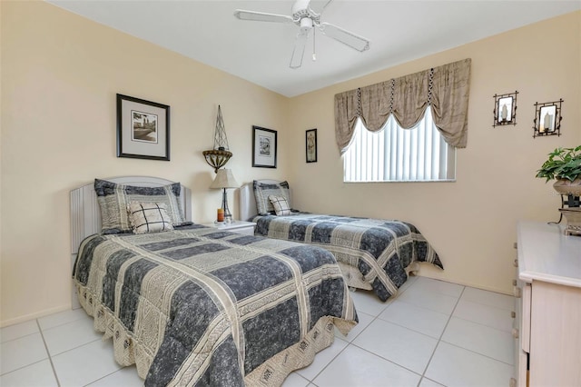 bedroom featuring a ceiling fan, baseboards, and light tile patterned floors