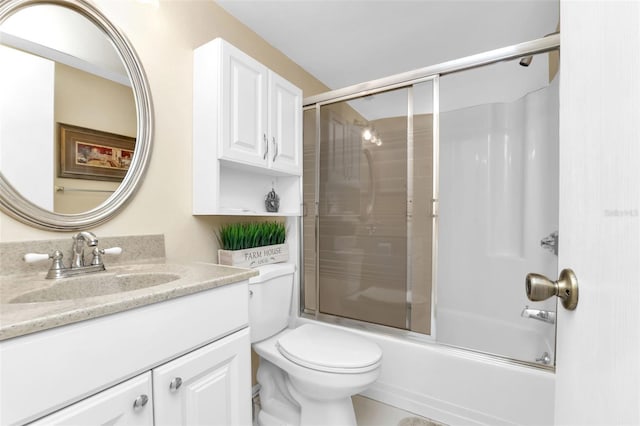 full bathroom featuring combined bath / shower with glass door, toilet, and vanity