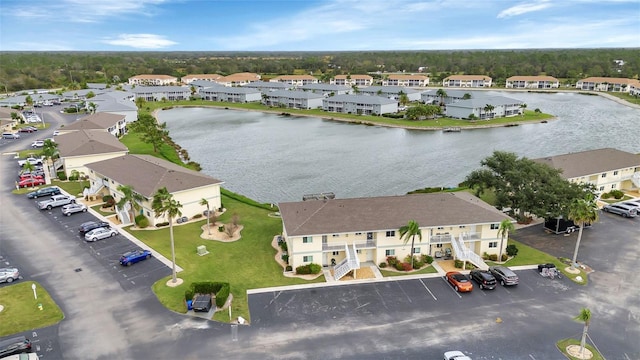 drone / aerial view with a water view and a residential view