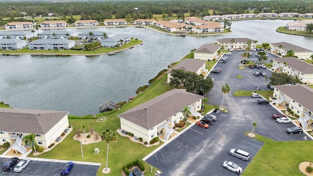 birds eye view of property with a water view and a residential view