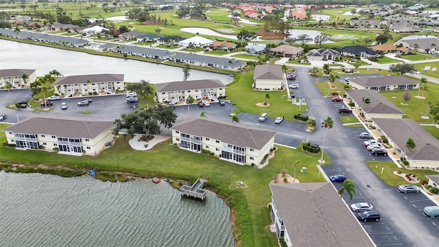 drone / aerial view featuring a residential view and a water view