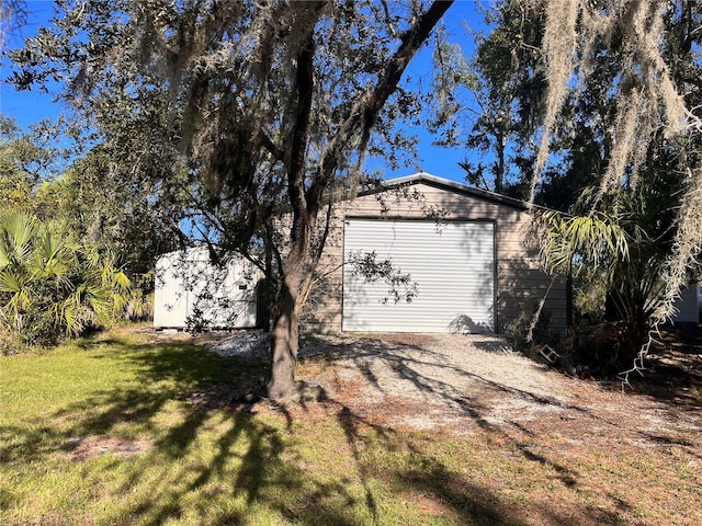 garage featuring a yard