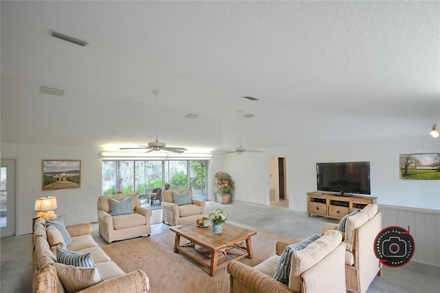 living room featuring vaulted ceiling, light colored carpet, and a textured ceiling