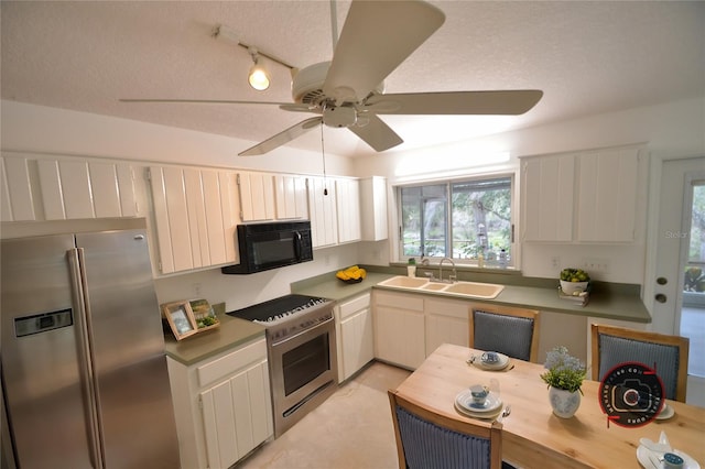 kitchen with sink, ceiling fan, stainless steel appliances, a textured ceiling, and white cabinets