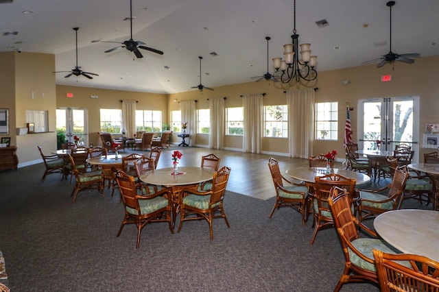 dining room featuring a notable chandelier and high vaulted ceiling