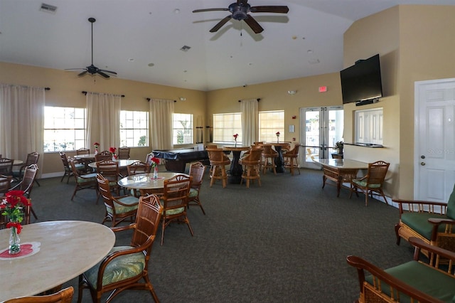 carpeted dining room with ceiling fan, french doors, and high vaulted ceiling