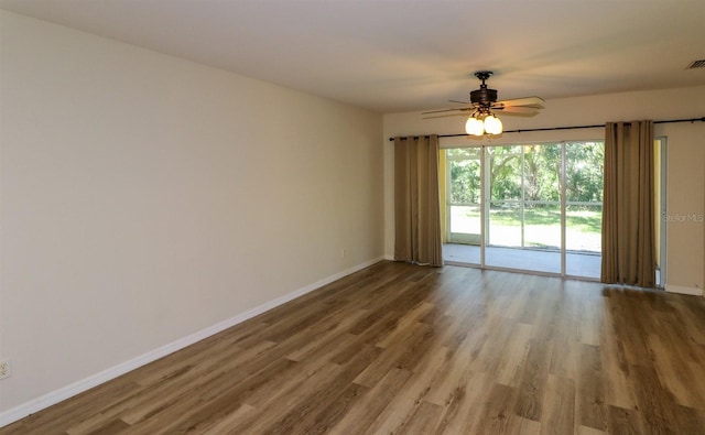 empty room featuring hardwood / wood-style flooring and ceiling fan