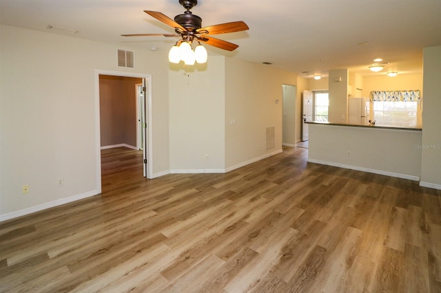 unfurnished living room with hardwood / wood-style flooring and ceiling fan