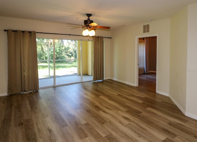 spare room with ceiling fan and wood-type flooring