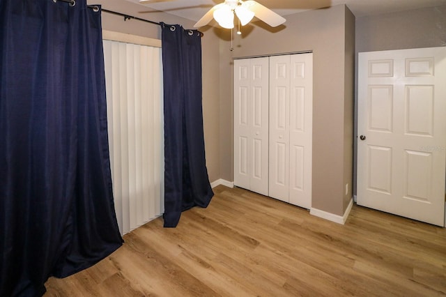 unfurnished bedroom featuring ceiling fan, light wood-type flooring, and a closet