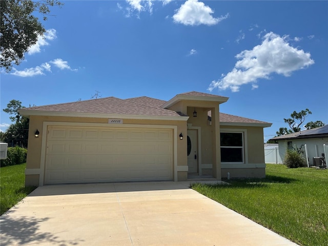 view of front of property featuring a garage and a front lawn