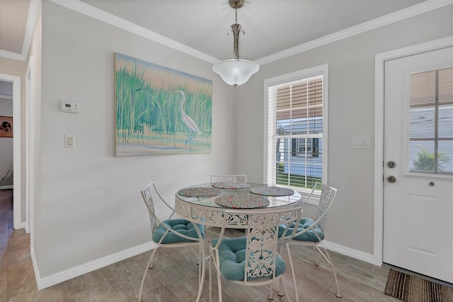 dining space featuring crown molding