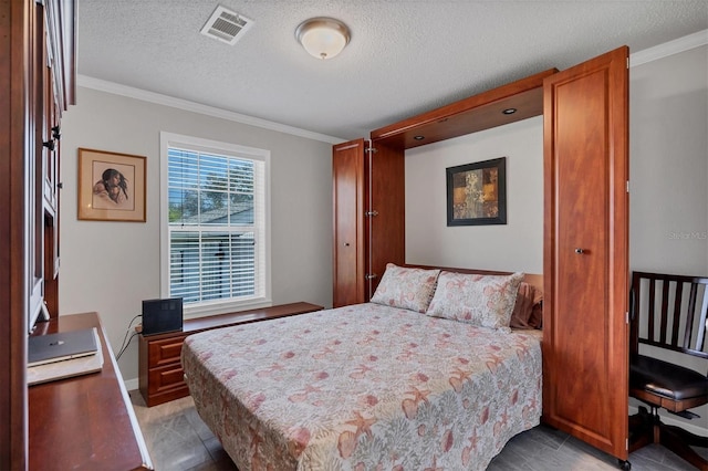 bedroom with a textured ceiling and ornamental molding