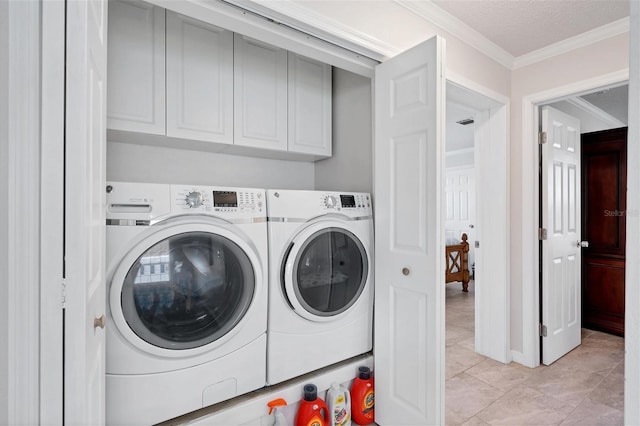 clothes washing area featuring cabinets, light tile patterned floors, separate washer and dryer, and crown molding