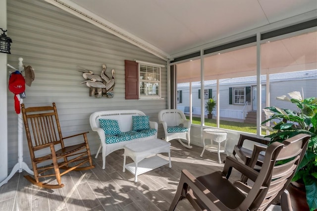 sunroom / solarium featuring lofted ceiling