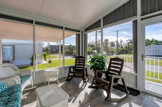 sunroom featuring vaulted ceiling