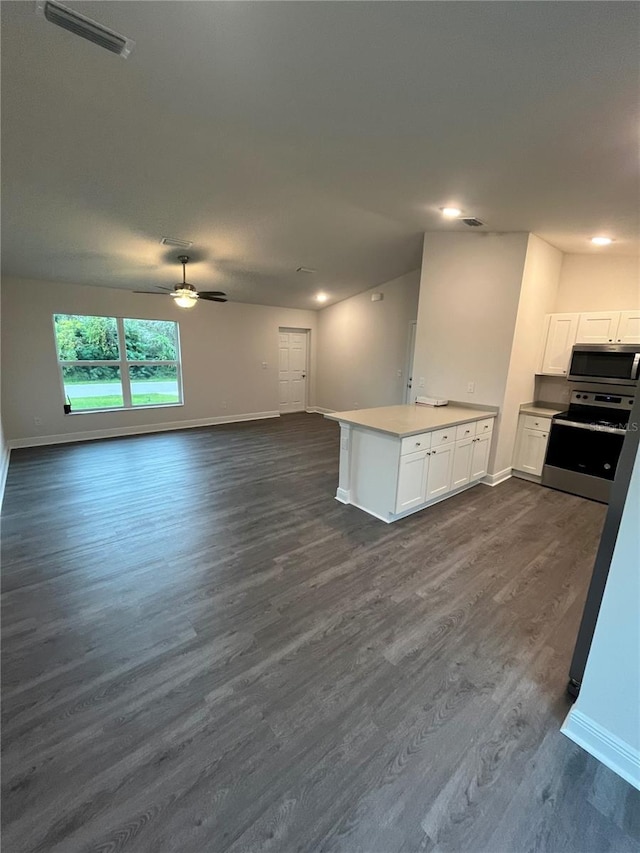 kitchen featuring ceiling fan, appliances with stainless steel finishes, dark hardwood / wood-style flooring, and white cabinetry