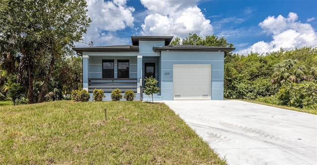 view of front of home featuring a garage and a front yard