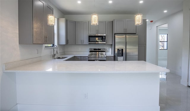 kitchen featuring gray cabinetry, light stone counters, plenty of natural light, and stainless steel appliances