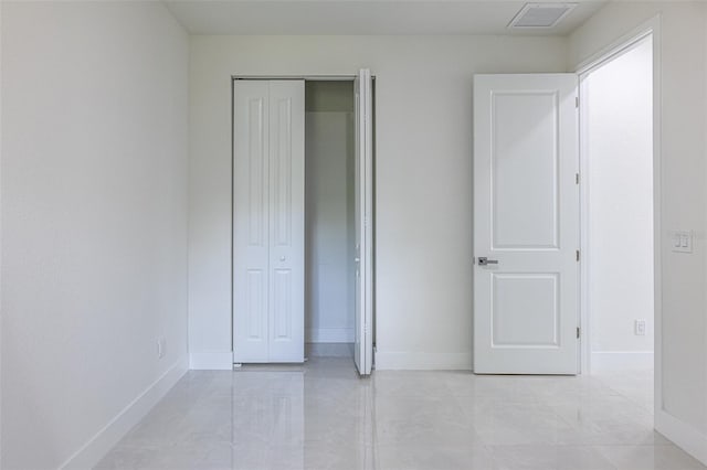 unfurnished bedroom featuring a closet and light tile patterned floors