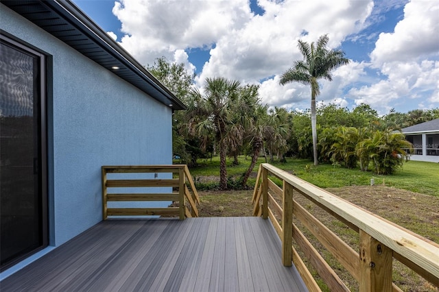 wooden deck featuring a yard