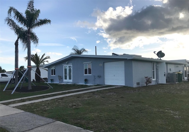 4127 Gardner Dr, Port Charlotte, FL 33952 - exterior space featuring a garage, french doors, a yard, central AC, and stucco siding