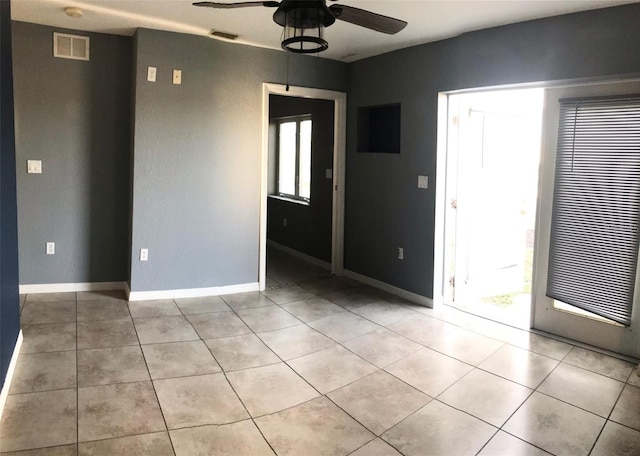 4127 Gardner Dr, Port Charlotte, FL 33952 - empty room featuring light tile patterned floors, baseboards, visible vents, and a ceiling fan
