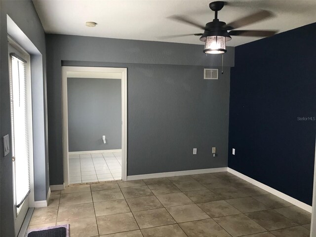 4127 Gardner Dr, Port Charlotte, FL 33952 - tiled spare room with visible vents, ceiling fan, and baseboards