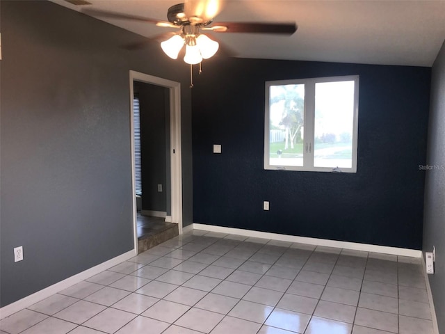 4127 Gardner Dr, Port Charlotte, FL 33952 - empty room featuring baseboards, vaulted ceiling, a ceiling fan, and light tile patterned flooring